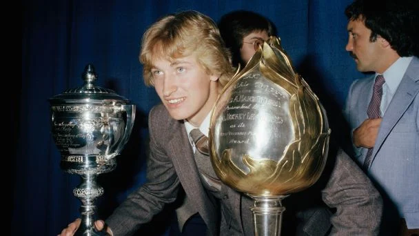 Wayne Gretzky poses for a photo after winning the Hart Memorial Trophy and the Lady Byng Memorial Trophy in 1980.