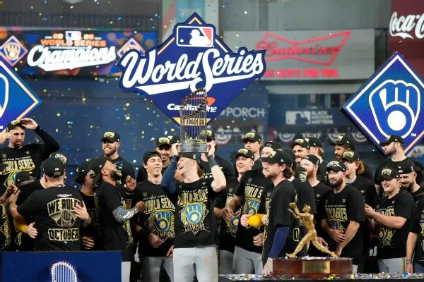 Milwaukee Brewers shortstop Cooper Pratt celebrates with the trophy after their in baseball's World Series against the Tampa Bay Rays.