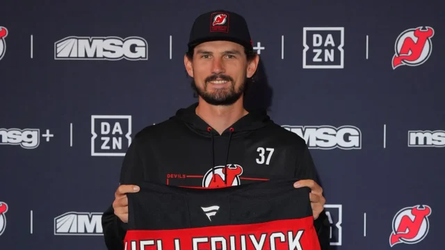 Connor Hellebuyck was all smiles about his sweater change to Devils gear.