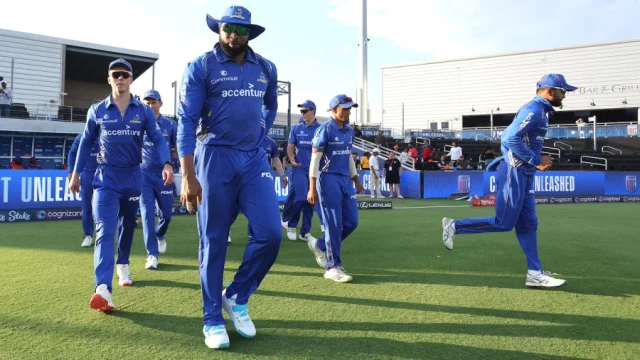 Kieron Pollard leads his team on to the field
