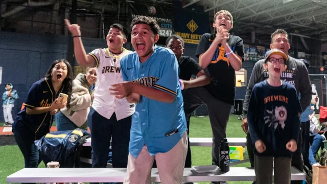Youth baseball players cheer on Milwaukee Brewers in World Series Game 1