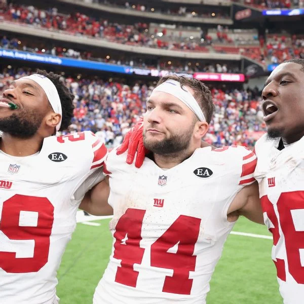Giants running backs, from left, Tyrone Tracy Jr., Cam Skattebo and Devin Singletary celebrate after Sunday's OT victory over the Texans.
