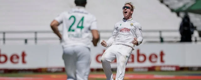 South Africa's Simon Harmer (R) celebrates after dismissing Australia's Alex Carey.