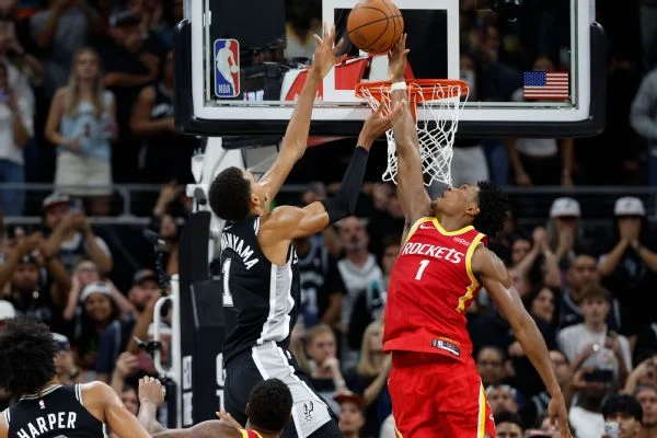 Amen Thompson swats away the Spurs' Victor Wembanyama at the rim with the Rockets leading by two in the closing seconds of Friday night's game.