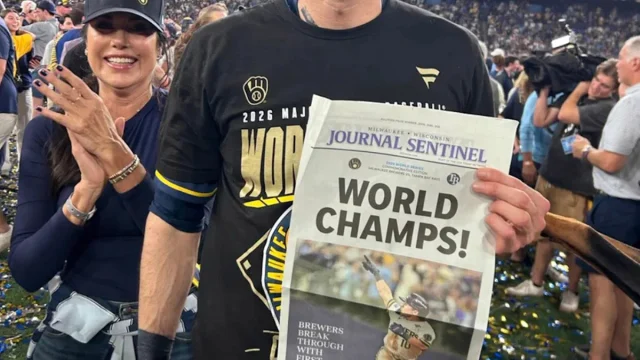 Players, coaches, fans holding World Series championship home page